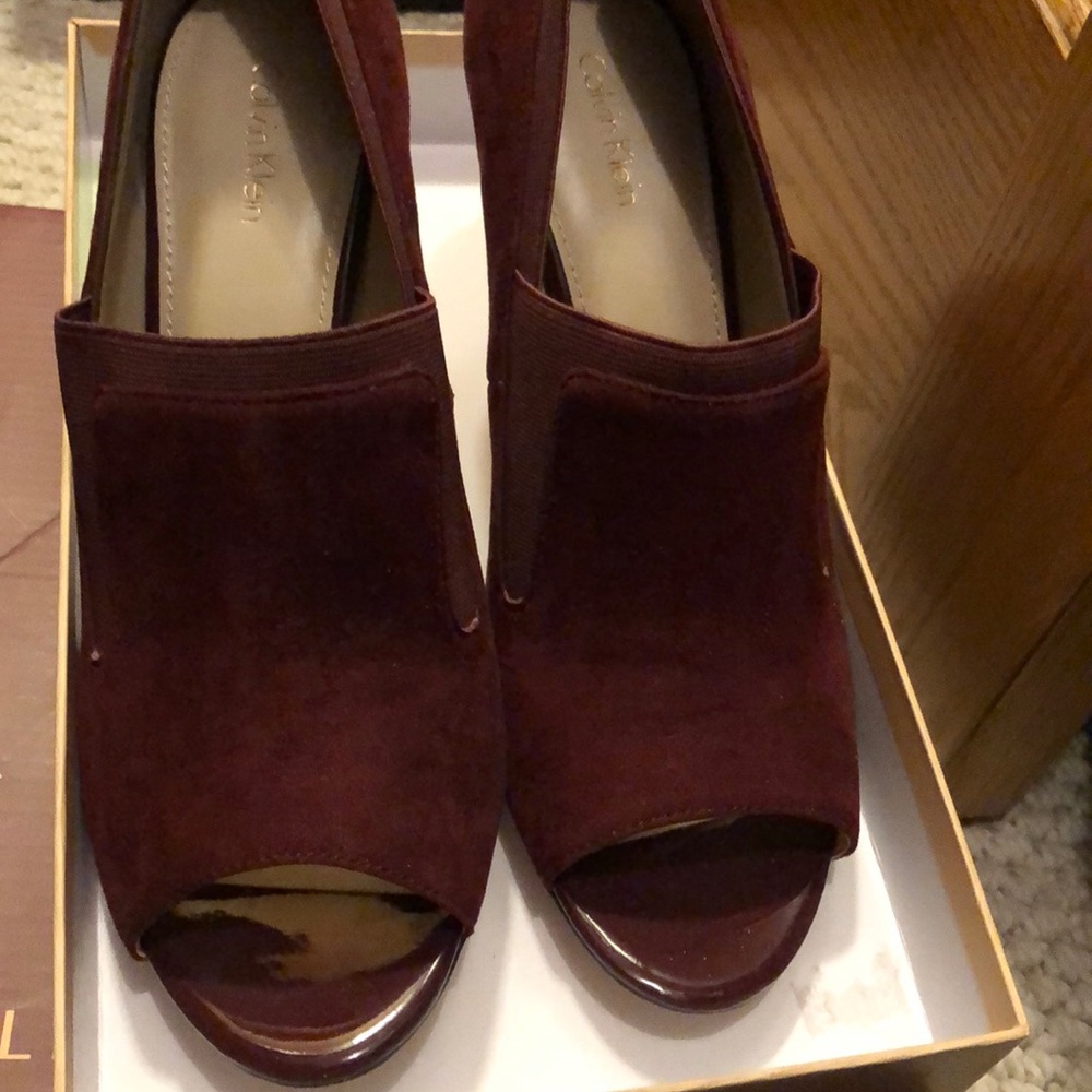 Burgundy suede open toe heels.